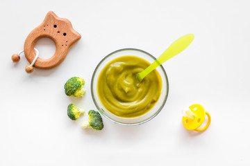 Mashed broccoli for feed babies on white background top view