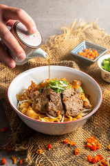 Noodles with meat and vegetables isolated, top view