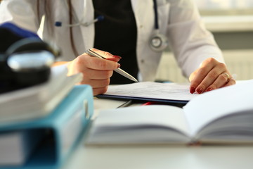 Female doctor hand hold silver pen filling