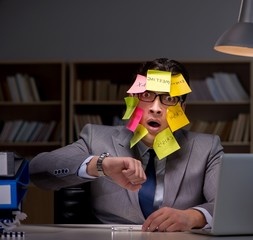 Businessman staying late to sort out priorities
