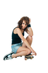 Pretty young brunette woman with a skateboard