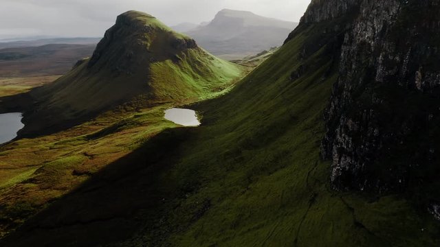 Stunning Landscape of Isle of Skye, Aerial. Trotternish Green Cliffs and Pond on Famous Island, Scotland, United Kingdom