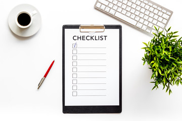 Checklist on white office background top view