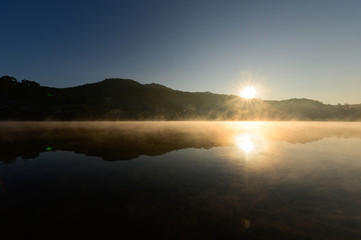 Fototapeta na wymiar sunrise with the fog over river