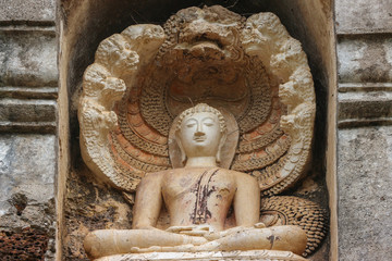 Thai old weathered Sukhothai art style Buddha statue background.