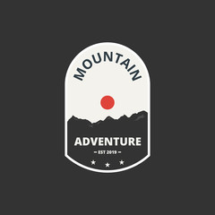 Mountain adventure badge and logo emblem. Label in vintage style. Vector illustration.