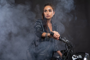 girl on a motorcycle in the smoke