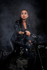 Obraz na płótnie Canvas girl on a motorcycle in the smoke