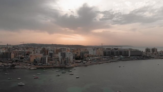 Aerial drone video from Malta, showing Qawra and Bugibba towns at sunset. MMXIX.VI.XI.
