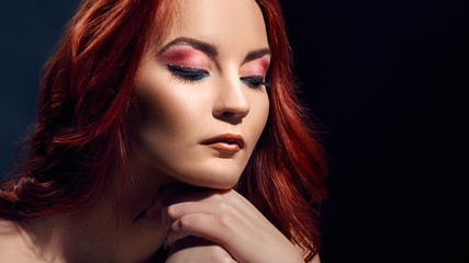 Fototapeta premium Romantic redheaded woman with bright makeup, perfect skin and curly hair