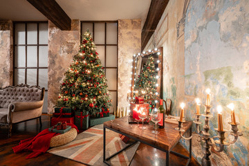 Winter home decor. Christmas in loft interior against brick wall. gifts under the tree. star lamp with light bulbs. Mirror garlands
