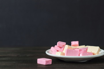 multi-colored candies in a plate with copy space