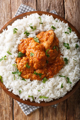 Parsi chicken dhansak is the quintessential comfort food. It is a yummy mixture of lentils, chicken, and well-blended spices close-up on a plate. Vertical top view