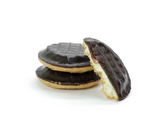 Biscuit cookies with jam and covered with chocolate. Close up. Isolated on white background