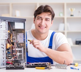 Computer repairman repairing desktop computer