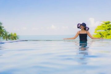 Obraz premium Portrait beautiful young asian women happy smile relax outdoor swimming pool in hotel