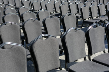 Rows of gray chairs. Street concert, conference, presentation.