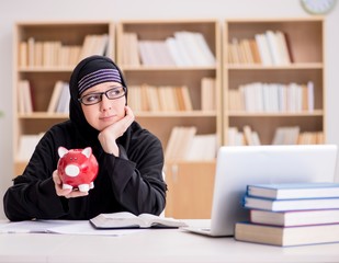 Muslim girl in hijab studying preparing for exams
