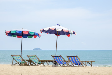Beach chair on white sand with sea wave and sunny. Relaxing on the beach.