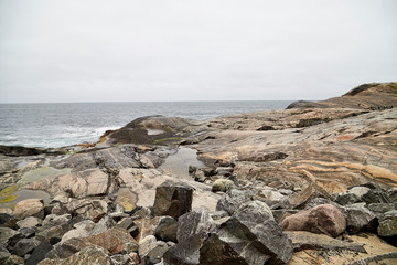Fototapeta na wymiar Norway landscape with rocky shore of the Northern sea in cloudy weather