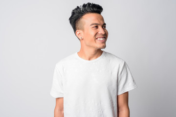 Face of happy young Asian man thinking