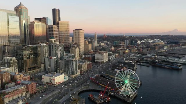 Seattle downtown, waterfront, piers, Alaskan Way with skyscrapers at dusk