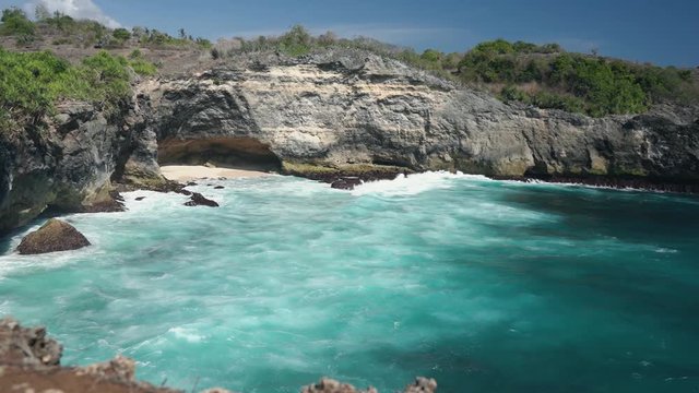 Ocean view to the Devill eye coast formation with blue lazure ocean water. Bali Indonesia