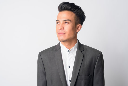 Face of young Asian businessman in suit thinking