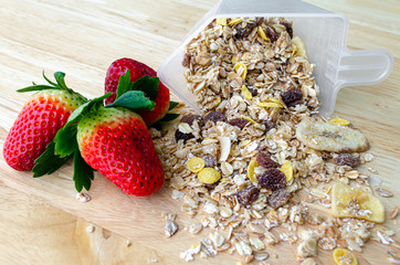 Muesli with fresh strawberries in measure cup