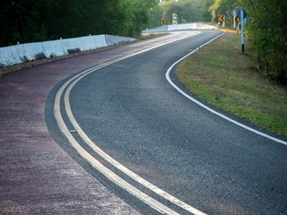 Obraz premium Road through natural areas With green trees