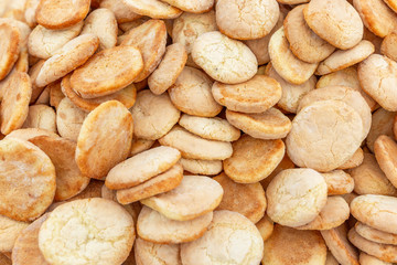 A lot of little white cookies. Background. Space for text. Close-up. Top view.