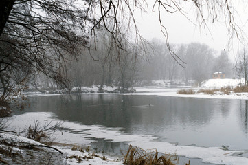 landscape of a winter river with open water and snowy shores