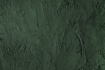 Dark green colored low contrast Concrete textured background with roughness and irregularities to your design or product. Color trend concept.