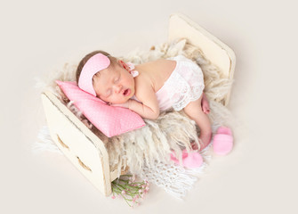 Fototapeta na wymiar Newborn sleeping in tiny bed