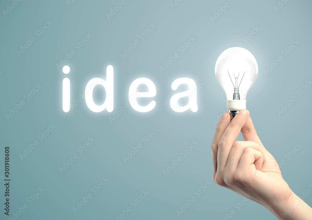 Poster hand holding light bulb in text idea.