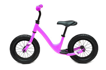 Fototapeta na wymiar A pink balance bike isolated on white background