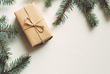 Craft gift boxe and fir branches on a black background. Top view, flat lay, copy space