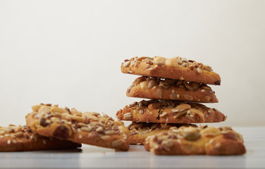 oat cookies chips and ingredients banana walnuts almonds raisin dried apricots on wooden table soft focus close up