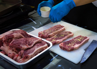 Butcher Cutting Raw Meat With Knife in the kitchen