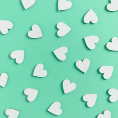 Pattern made of white hearts on mint background