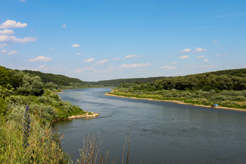 Fototapeta na wymiar Landscape with a beautiful wide river in summer.