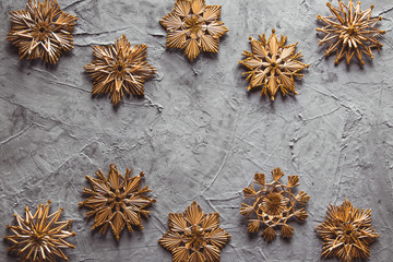 New Year's straw toys, on a gray concrete background. Christmas card