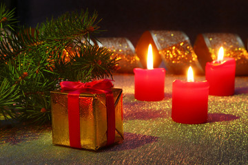 Holiday decoration with gift boxes, christmas candles, tree and colorful christmas balls. Selective focus.