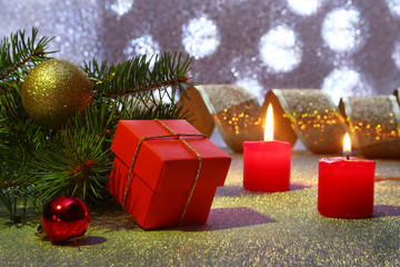 Holiday decoration with gift boxes, christmas candles, tree and colorful christmas balls. Selective focus.