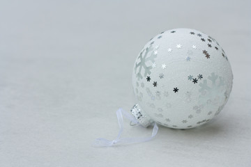White christmas ball on light background.