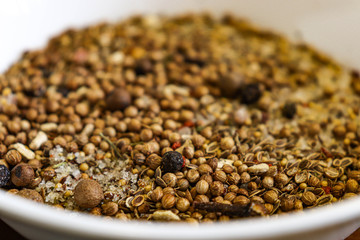 Closeup spice mix: salt, pepper, mustard, cloves. Can be used for harvesting homemade canned goods.