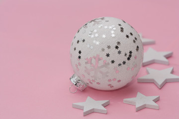 White christmas ball on light pink background.