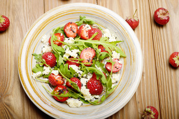 Flat lay detox strawberry arugula and feta cheese salad with chia seeds and sesame