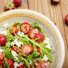 Flat lay detox strawberry arugula and feta cheese salad with chia seeds and sesame