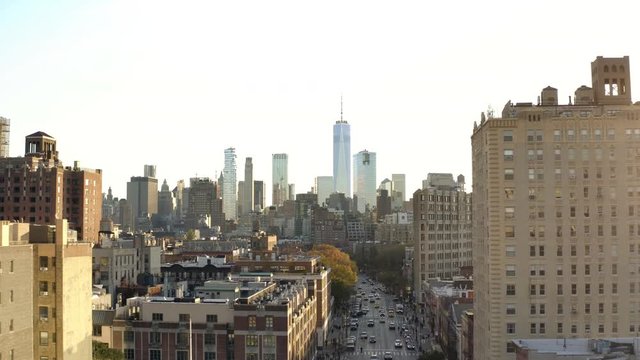aerial pulling back high over 6th Ave cars in traffic with Freedom Tower in Manhattan cityscape New York City NYC